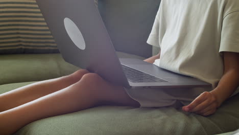 Close-Up-Of-The-Hands-Of-A-Little-Girl-With-The-Laptop-On-Her-Lap