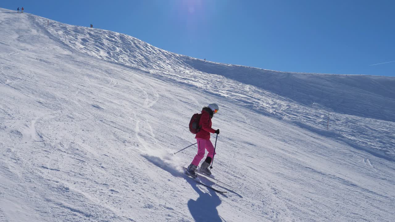 Skier Skiing Down The Ski On The Mountain Slope And Turning The Snow Spray