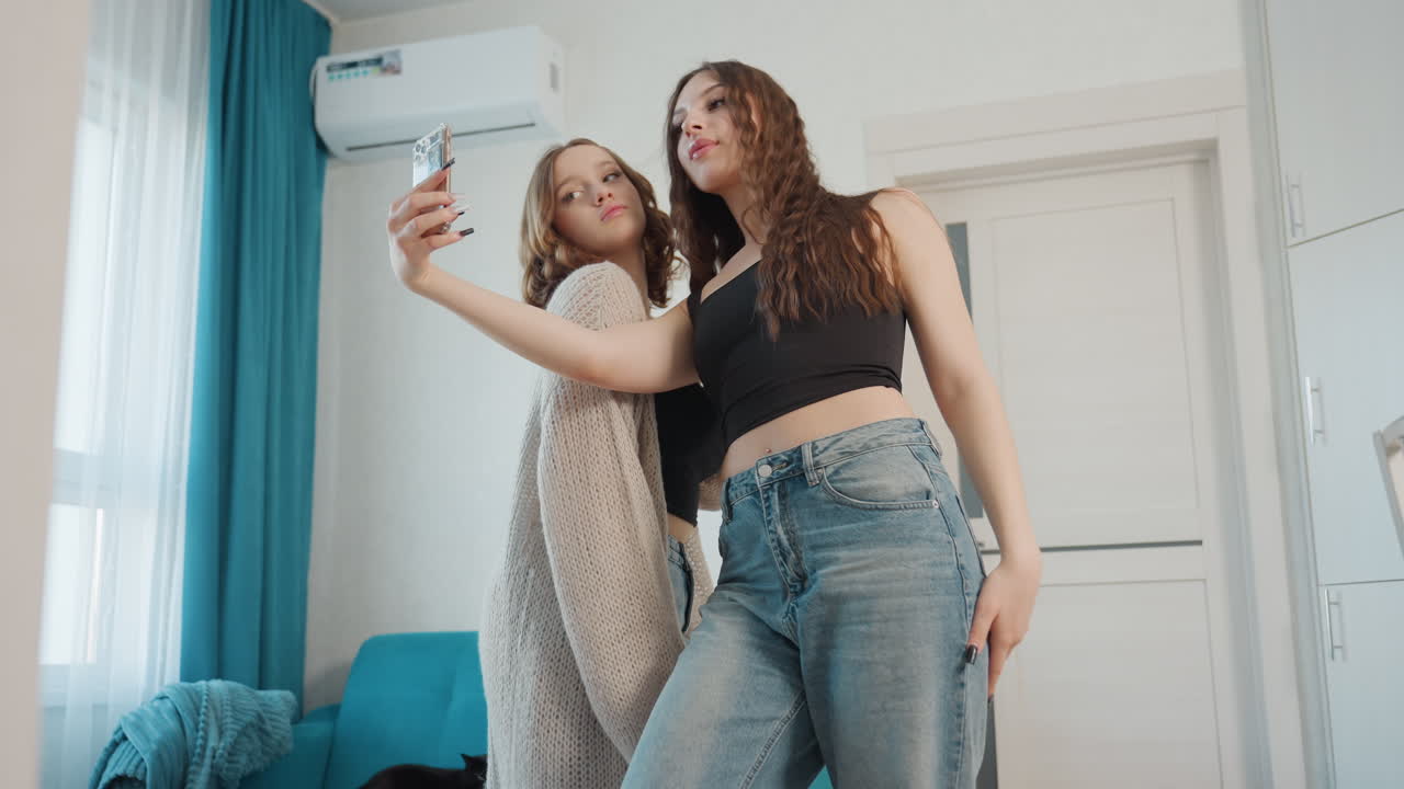 Friendly Women Embrace And Smile Warmly, Conversing Women In Comfortable Home Creating Joyful Memories Together, Two Women Sharing Heartfelt Hug And Candid Photo In Inviting Living Space