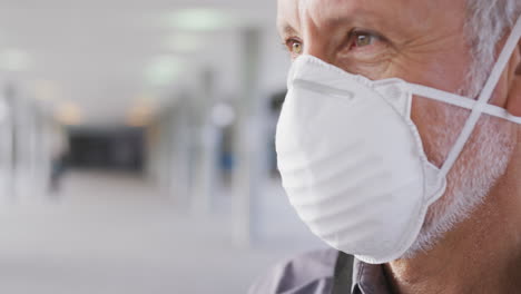 Caucasian-man-out-and-about-in-the-street-wearing-on-a-face-mask-against-coronavirus