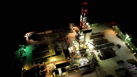 topdown view of fixed offshore oil platform illuminated at night