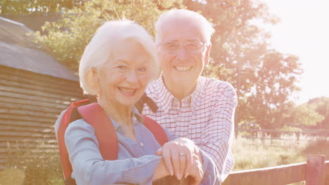 portrait of senior couple hiking in countryside together