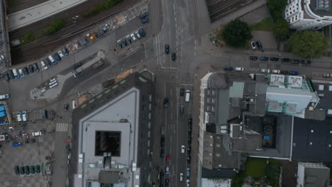 Aerial-birds-eye-overhead-top-down-view-of-multilane-road-leading-between-buildings-and-across-railway-tracks.-Fly-over-urban-neighbourhood.-Free-and-Hanseatic-City-of-Hamburg,-Germany