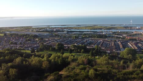 left to right drone across houses, marina with trees foreground