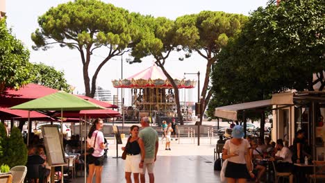 people enjoying a day near carousel and restaurant