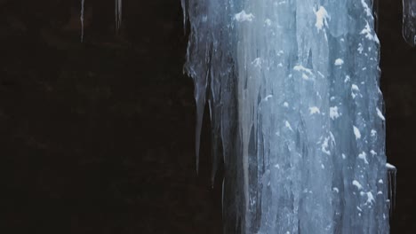 frozen waterfall and icicles at the ash cave during winter in hocking hills, ohio, usa