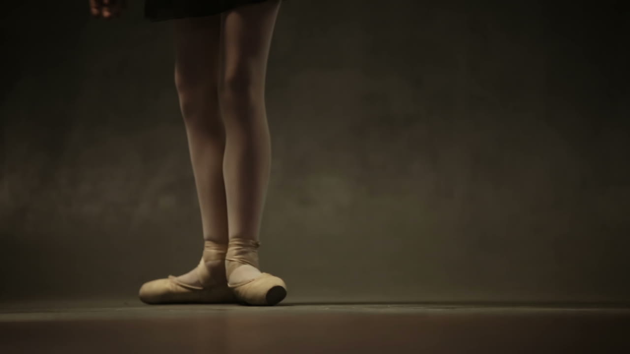 Young beautiful girl ballerina against studio background