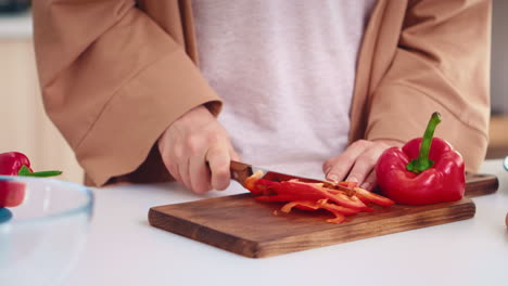 hands close up slicing pepper