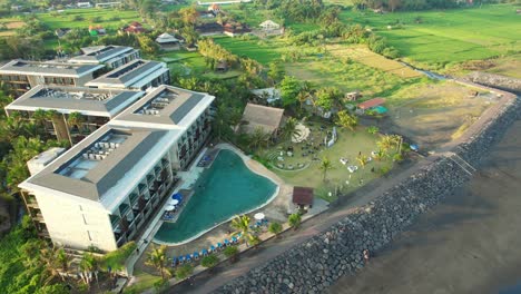 exterior of wyndham tamansari jivva resort bali under sunset sunlight in klungkung bali, indonesia - aerial parallax