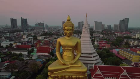 aerial orbit phra buddha dhammakāya thepmongkhon at dusk bangkok, thailand