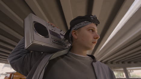 young man posing with stereo