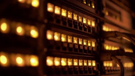 a detailed look at a server rack in a data center where lights are flickering as technicians perform routine checks late at night. the atmosphere is technical and focused on maintenance.