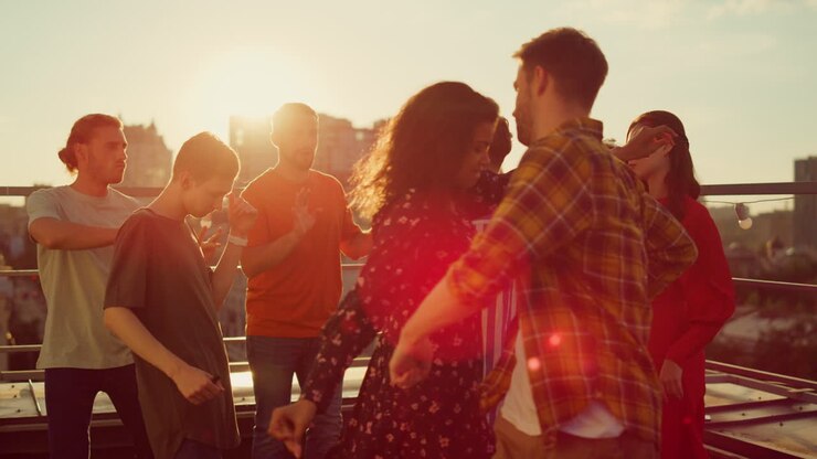 Multiracial couple dancing at roof party. People having fun at open air disco.