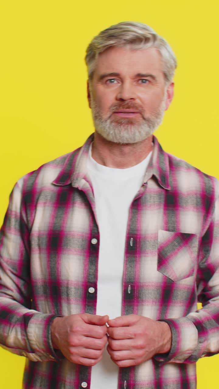 Mature man urging donations heartfelt plea pointing down gesture support call genuine gratitude