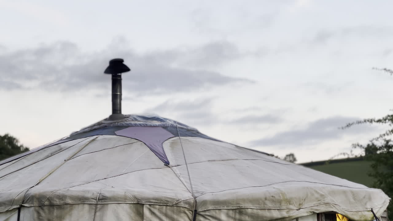 Yurt chimney tent with smoke from a cosy fire log burner