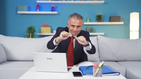 Home-office-worker-man-makes-a-trust-sign-to-the-camera.