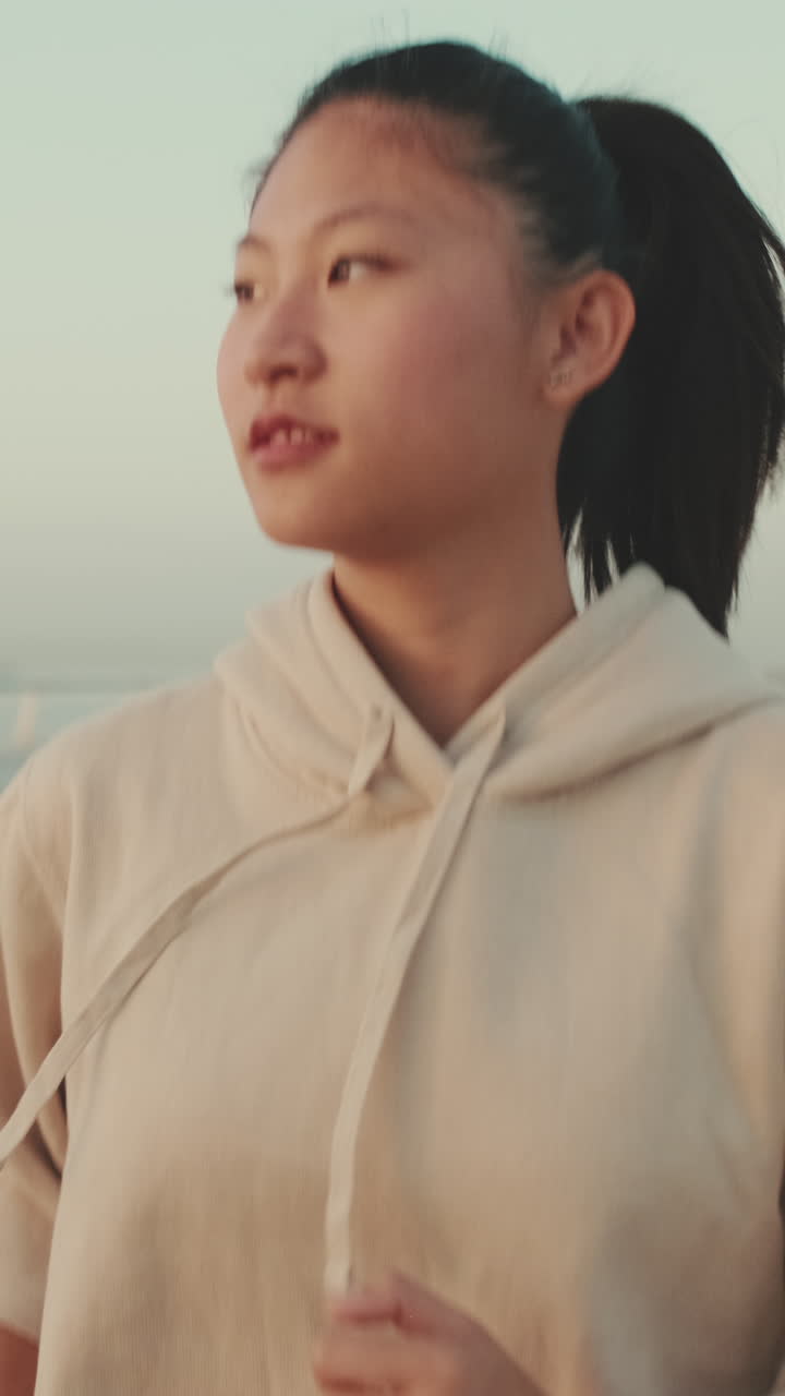 Woman in hoodie at the beach