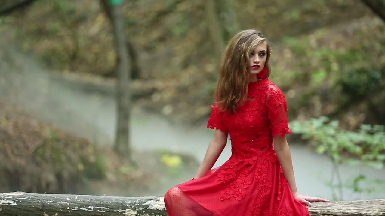 Mysterious Girl Walking In The Forest. Mysterious girl in long red dress walking in the forest