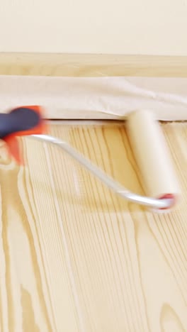 vertical shot of priming a hardwood floor for a diy home project