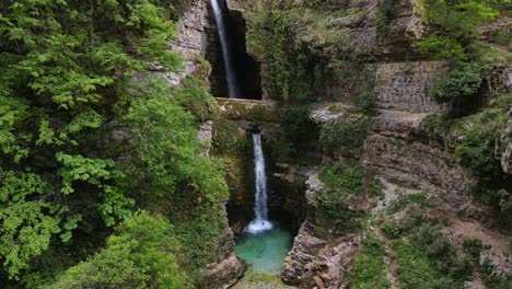 a man swimming in the ujëvara e peshturës waterfall in albania