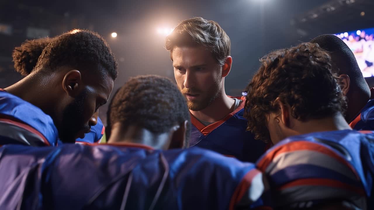 A football team gathers in a huddle, emphasizing strategy and teamwork ...