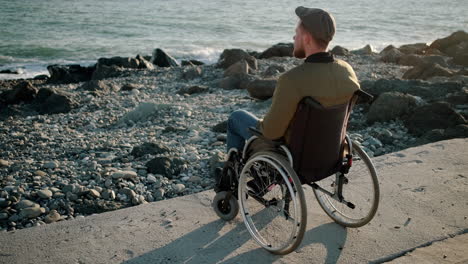 man in wheelchair at the beach