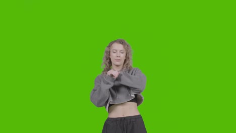 studio shot of young woman having fun dancing against green screen 8