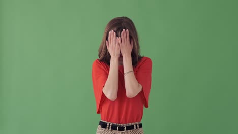 woman covering her face and looks out from hands