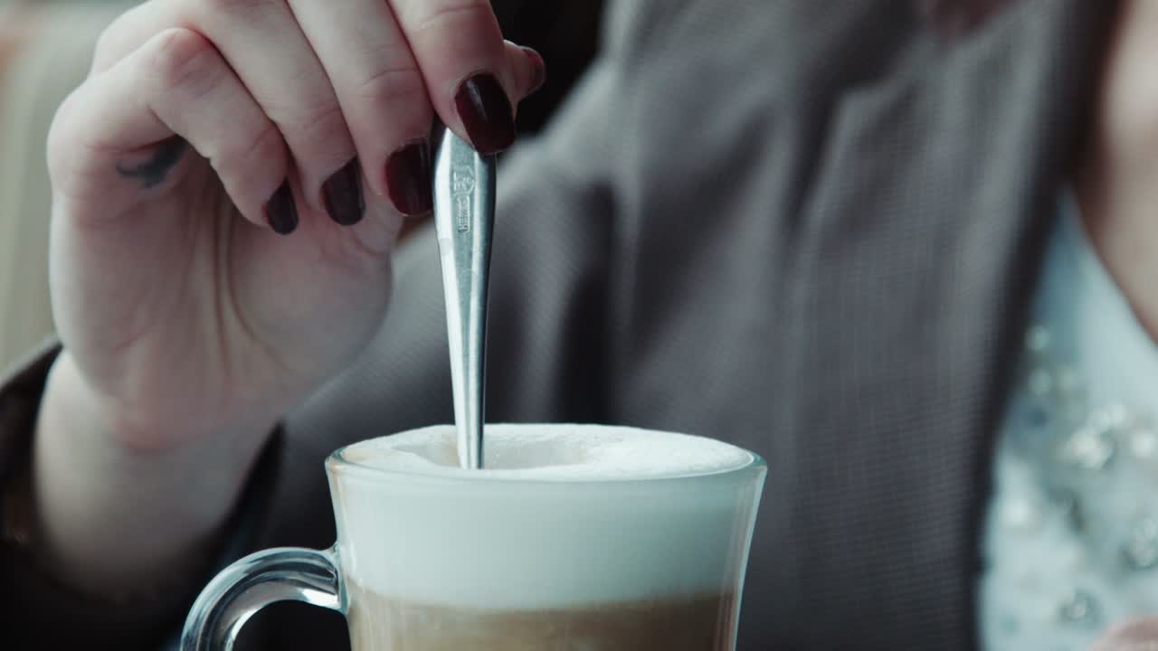 The Girl Fills Sugar In Coffee And Stirs