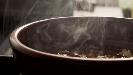 pan with steaming dish in kitchen