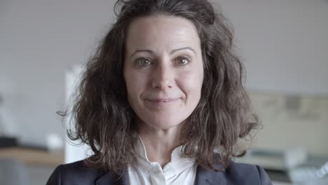 attractive middle aged businesswoman smiling at camera