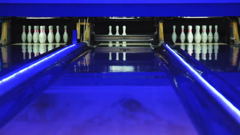 Colorful-bowling-alley.-Bowling-ball-knocks-down-7-pins.-Ball-is-rolling