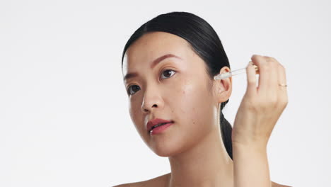 Asian-woman,-serum-and-retinol-on-face-for-beauty