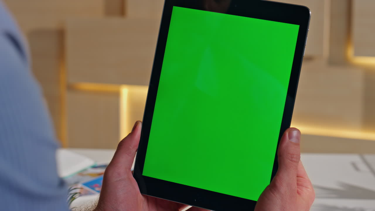 Businessman hands holding greenscreen tablet at work space close up. Unknown man
