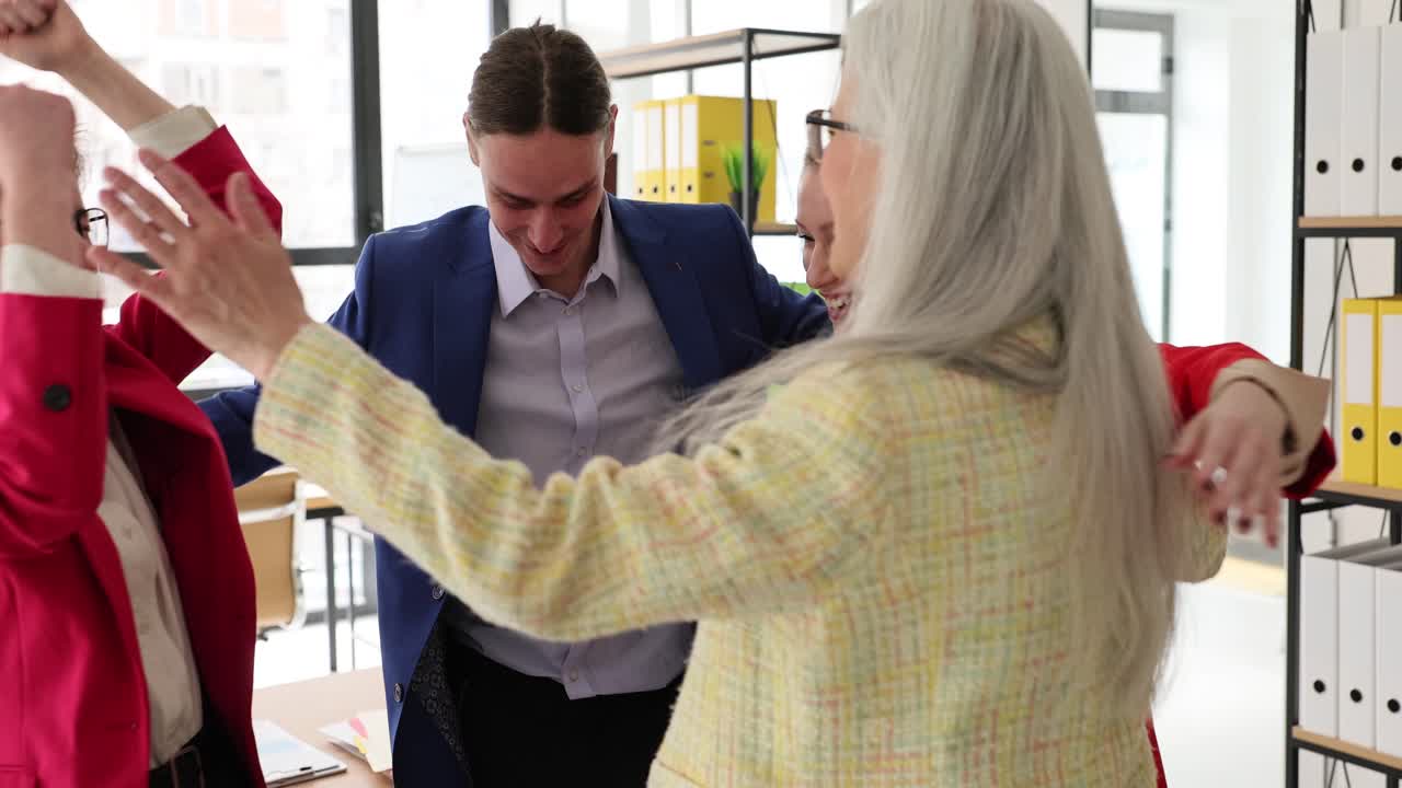 Happy Business Team Hugging in the Office