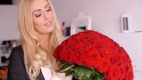 mujer feliz con un bouquet de rosas rojas frescas