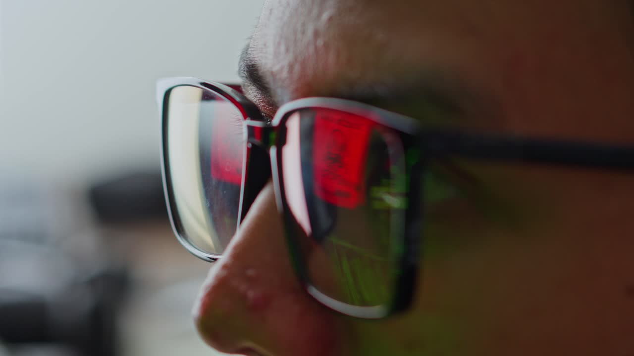 Extreme close-up of hacker or IT expert's eyes with digital security alert reflected