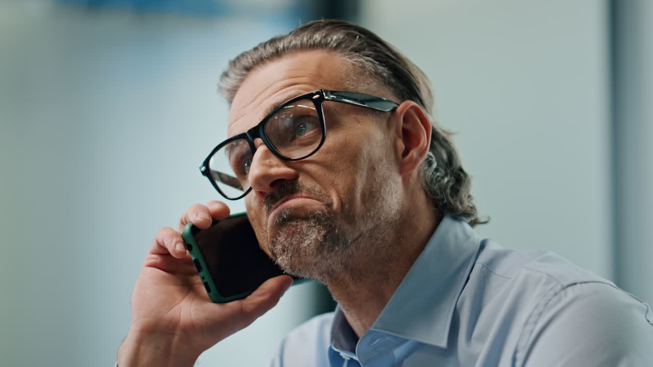Confident businessman talking cellphone closeup. Serious ceo calling mobile