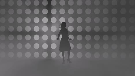 a modern youth dance performed by a graceful and sexy female silhouette, in the smoke against the backdrop of spotlights.