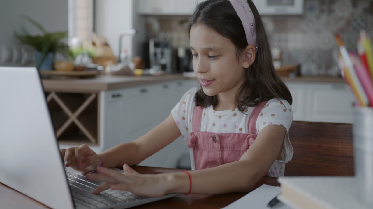 Girl Studying on Laptop in Kitchen
