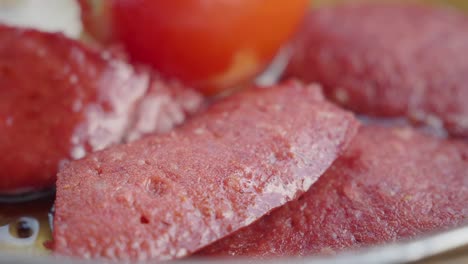 close-up of sausage and tomato