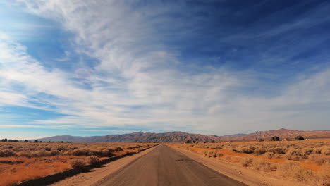 hyperlapse driving on highway in golden brown mojave desert landscape