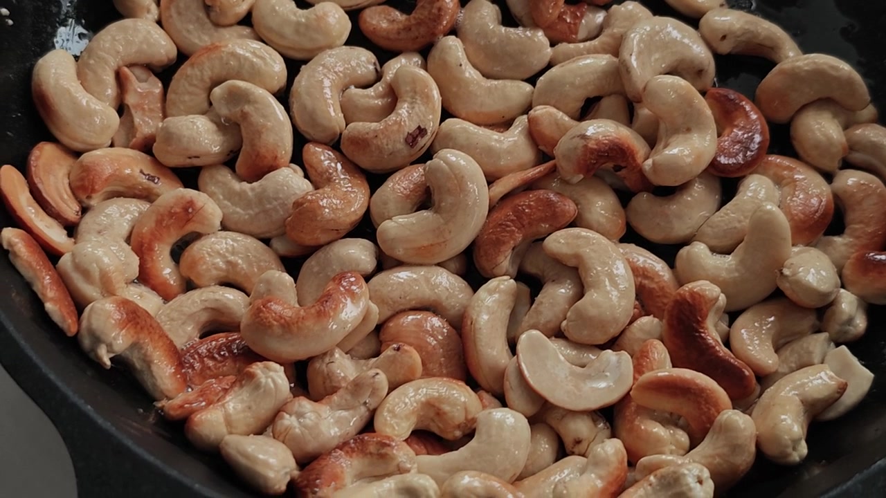 Ultra Cinematic Slow Motion Cashew Roasting in Black Pan with Olive Oil Sparks, Macro Food Art Close-Up, Crunchy Golden Transformation, Gourmet Kitchen ASMR Visual Feast 4K HDR Viral Stock Footage NOW