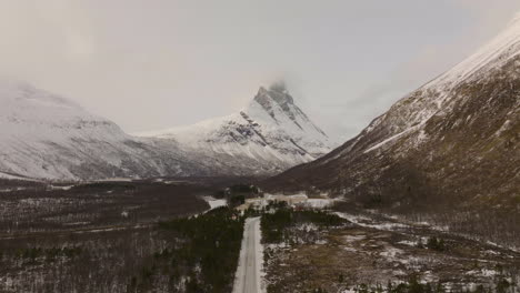 massive snowy mountains ranges and the famous otertinden mountain in northern norway - aerial shot