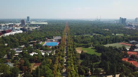 aerial view of city park with long road and buildings
