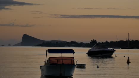 a quiet scene of two anchored boats taken just before dawn