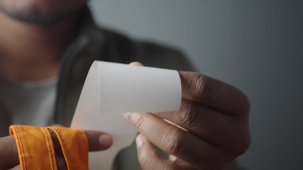 Person Holding a Roll of Paper