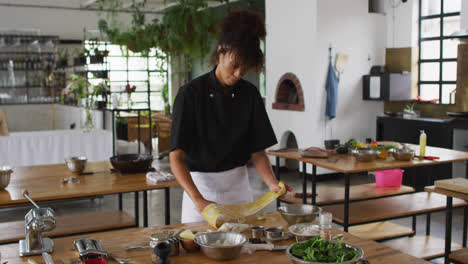 diverse group of chefs preparing dishes and smiling in a kitchen