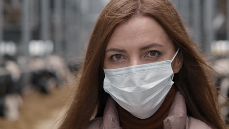 portrait of woman in face mask in workplace