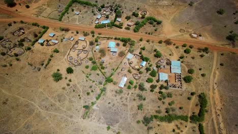 aerial drone view of the arid region of karamoja, uganda where there are traditional and modern houses, on a sunny day